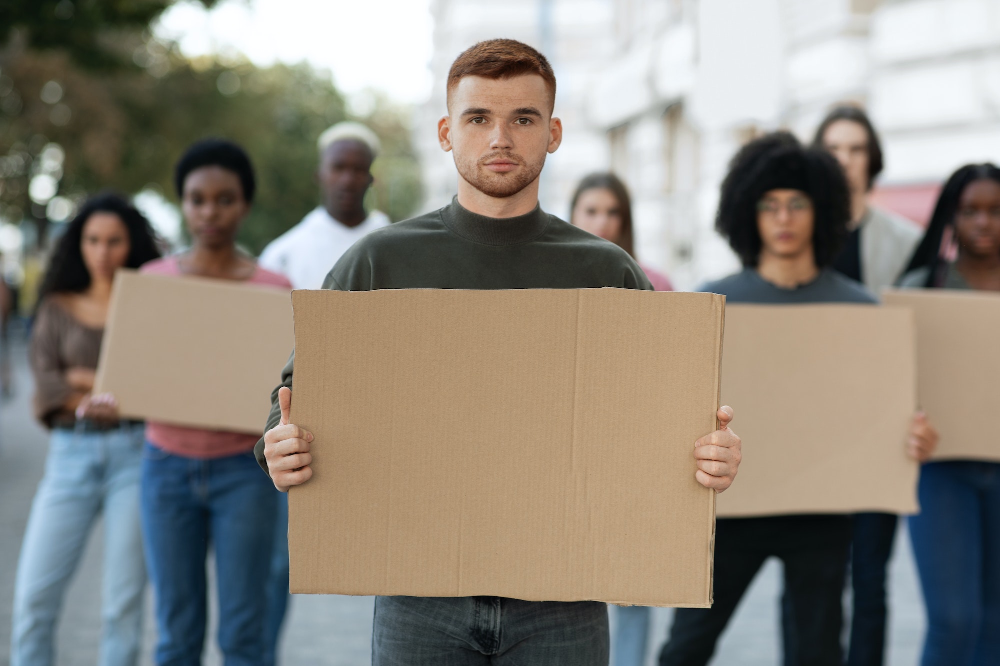 International group of young people strikers with blank placards