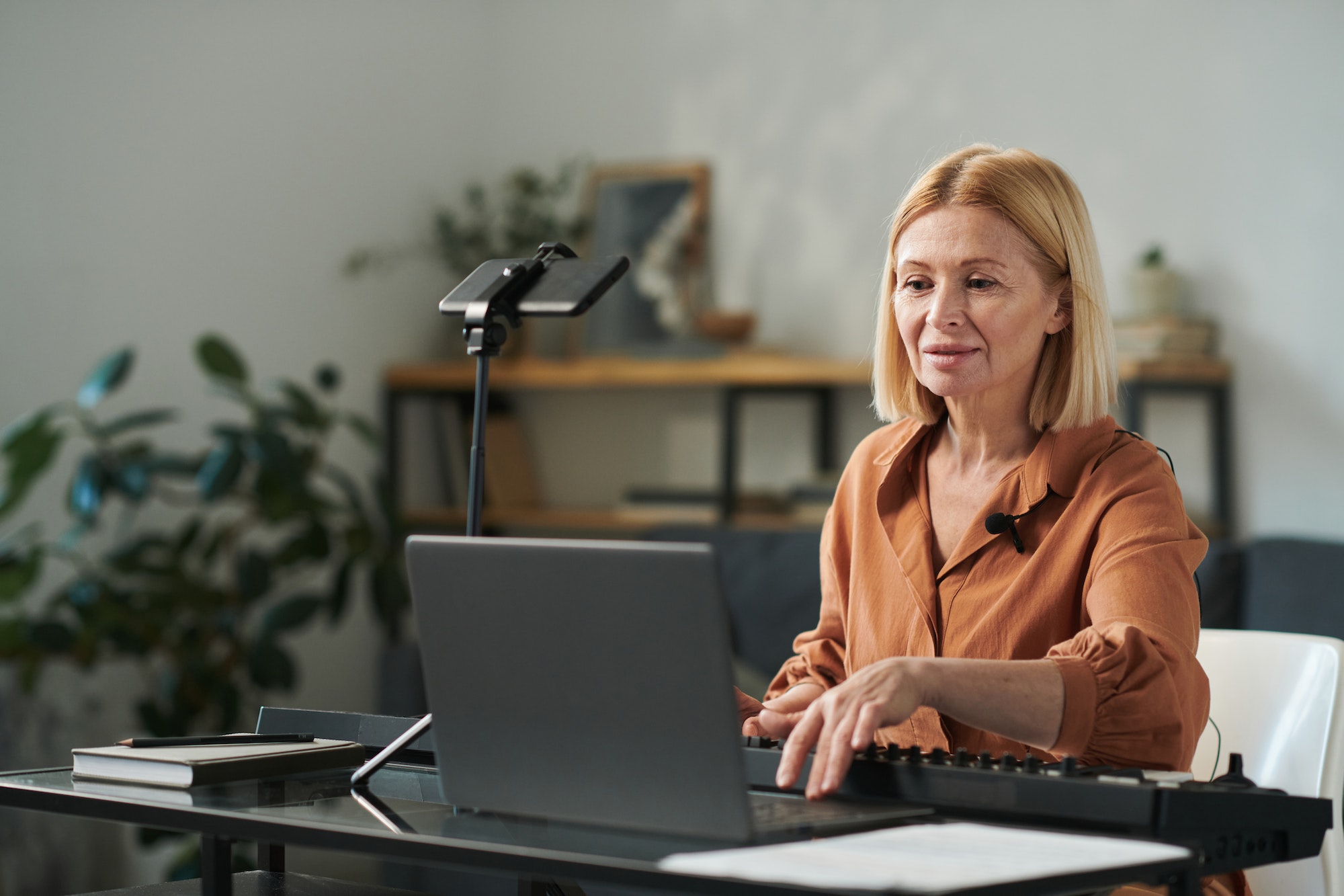 Music teacher turning on laptop for lesson